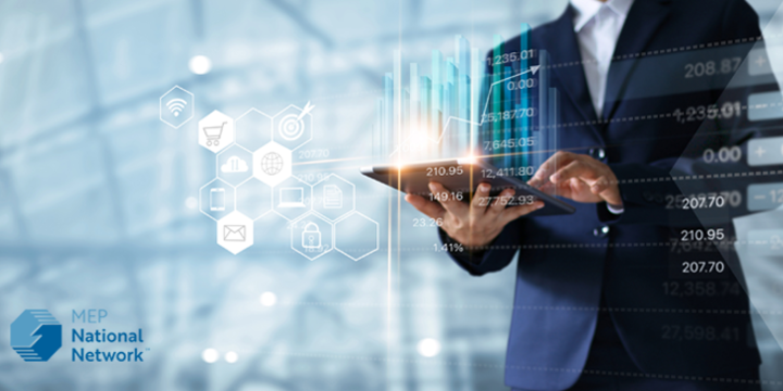 man in a suit holding an ipad in an industry
