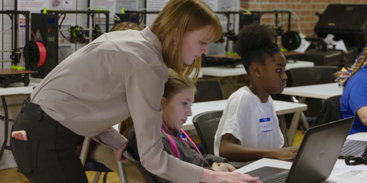 Ashley Totin, project engineer at America Makes, teaches children about 3D modeling and printing.