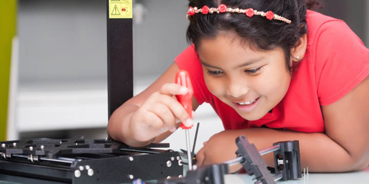 girl working on a 3D printer
