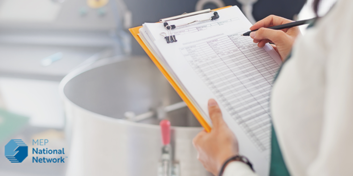 Woman checking quality of food in a manufacturing facility