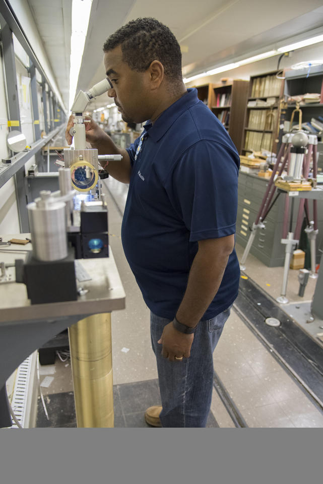 A scientist looking in a microscope