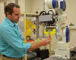 Man works with a robot