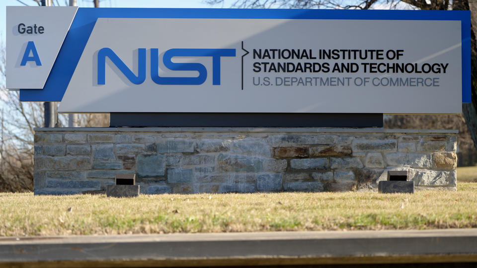 Outdoor sign in close-up view reads: NIST: National Institute of Standards and Technology: Gate A