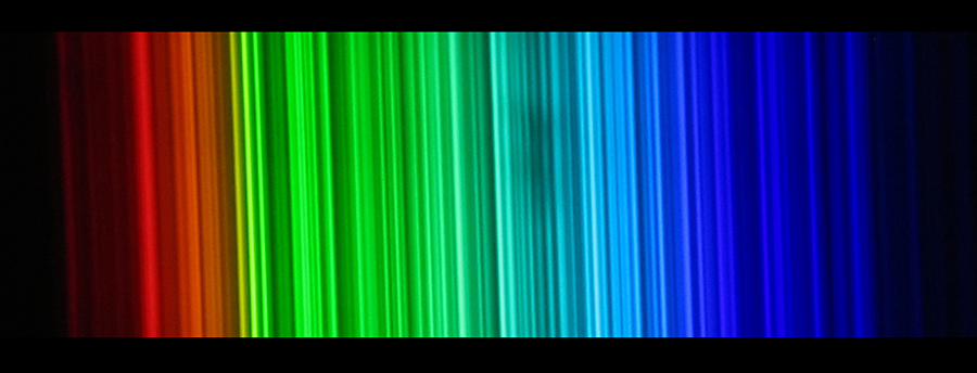 Vertical lines of light change from red to green to blue going left to right.