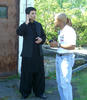 photo of two men using a smart phone voice translation system
