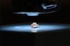 Bullet fragment is illuminated under microscope lens.