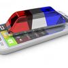 A smartphone on a white background with red / white / blue emergency lights sitting on top of the phone