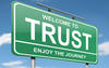 Green road sign that says Welcome to Trust, Enjoy the Journey