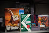 Boxes of old software stand on a shelf, inlcuding a flight simulator, Dark Souls II and a Kaspersky anti-virus product.