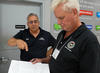 David Sefcik reviews an inspection report with a Massachusetts Weights and Measures Official James Shattuck