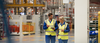 Workers walking through a factory having a discussion