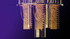 Close up of a quantum computer with a black and purple ombre background.